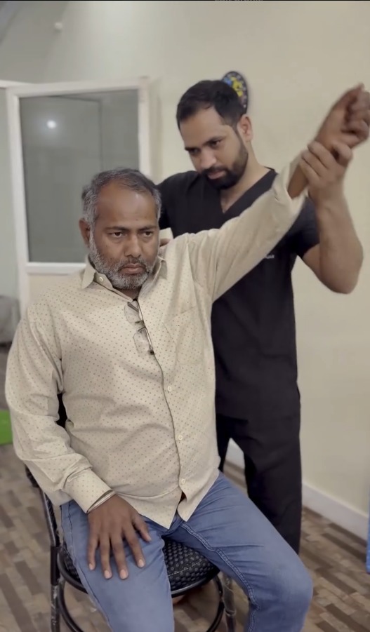 Therapist guiding a shoulder mobility exercise